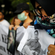 A woman holds a picture of a relative, one of the 189 people killed in a Lion Air plane crash, during a rally calling for Lion Air to put safety over profit and for Indonesian President Joko Widodo to ensure all remains were recovered, in Jakarta, Indonesia December 13, 2018.